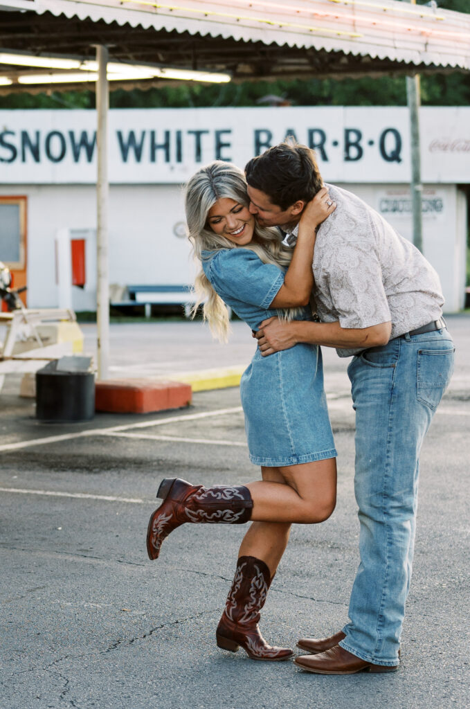 Engaged couple in front of drive in diner