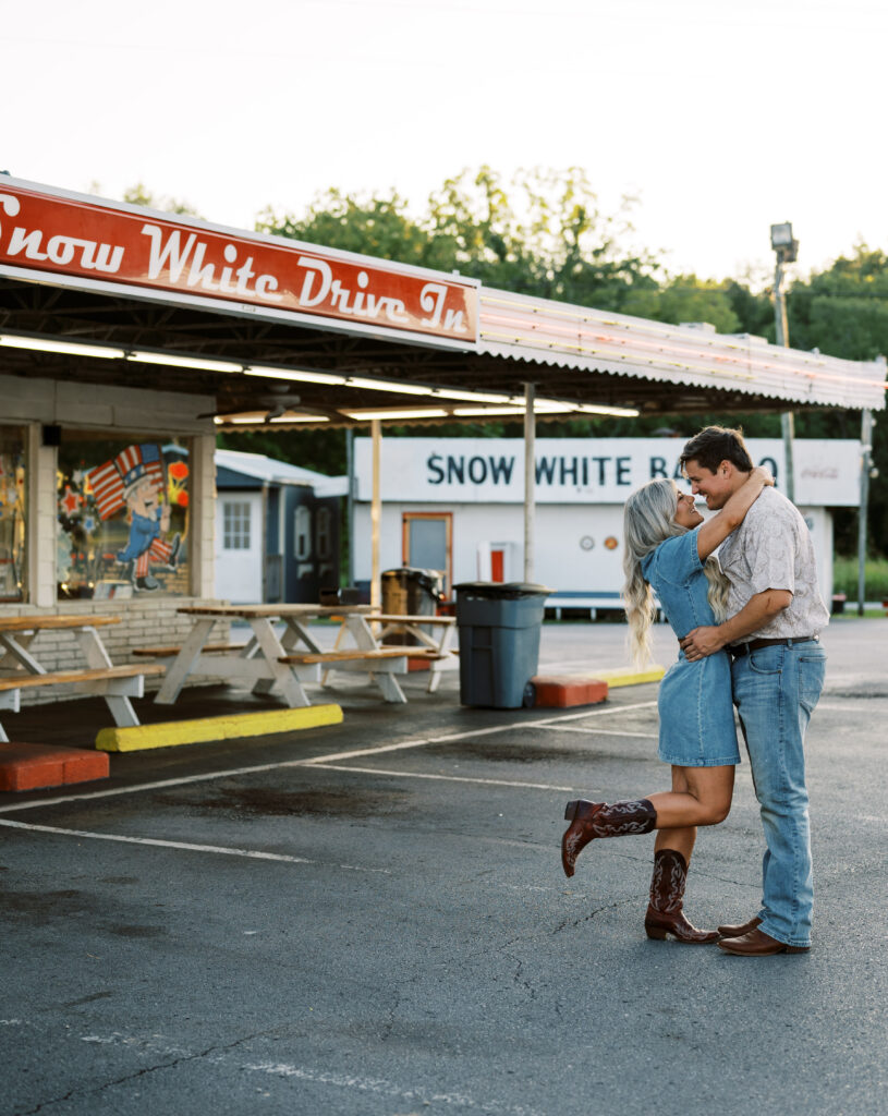 Engaged couple in front of drive in diner