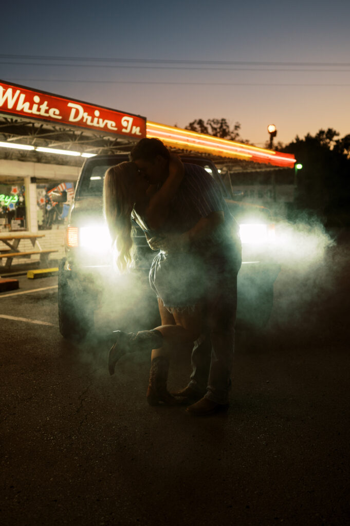 Engaged couple in front of drive in diner