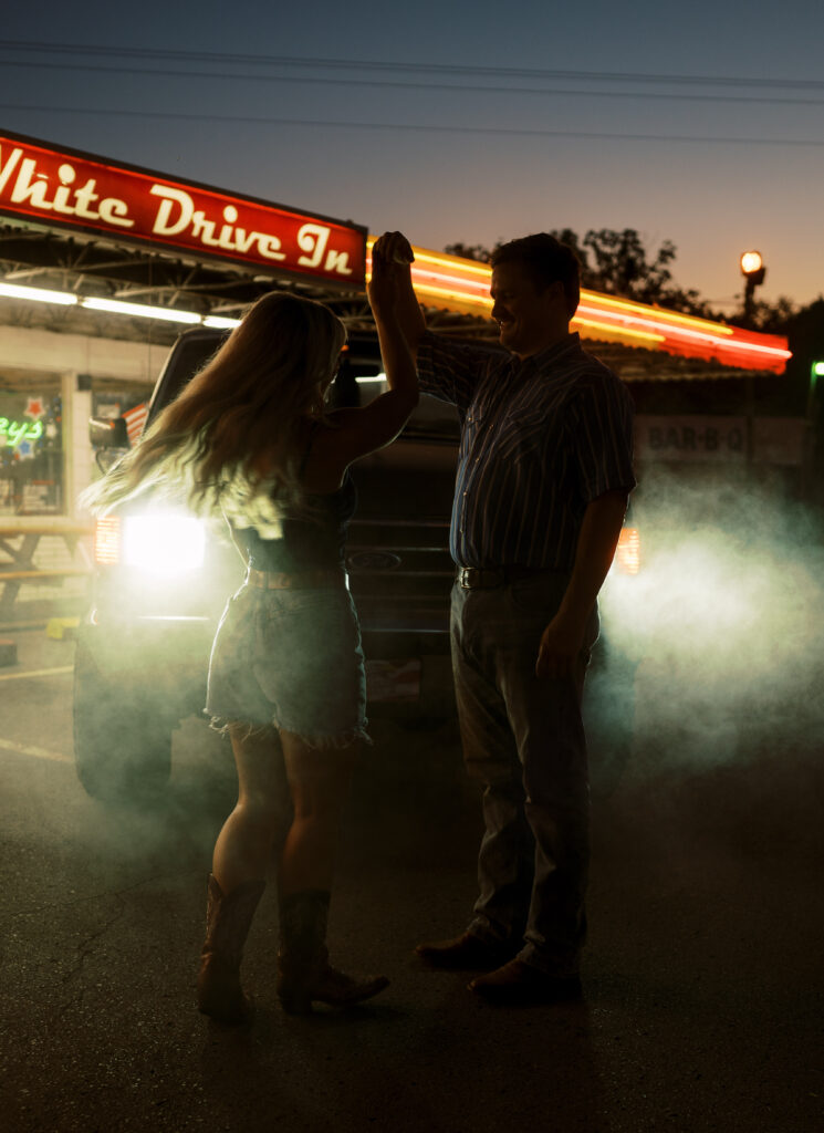 Engaged couple in front of drive in diner