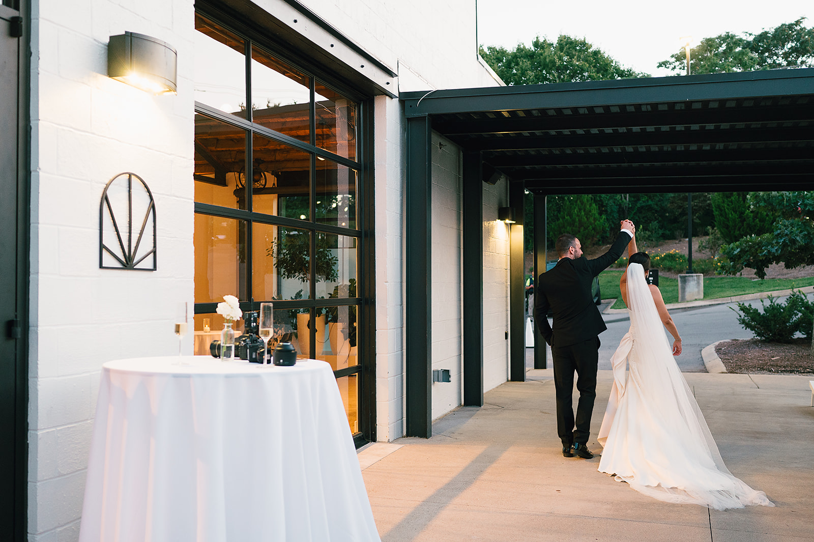 Newlyweds dance and twirl on the patio of Saint Elle Wedding venue