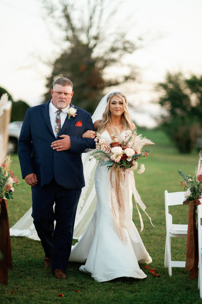 Father walks bride down the aisle.