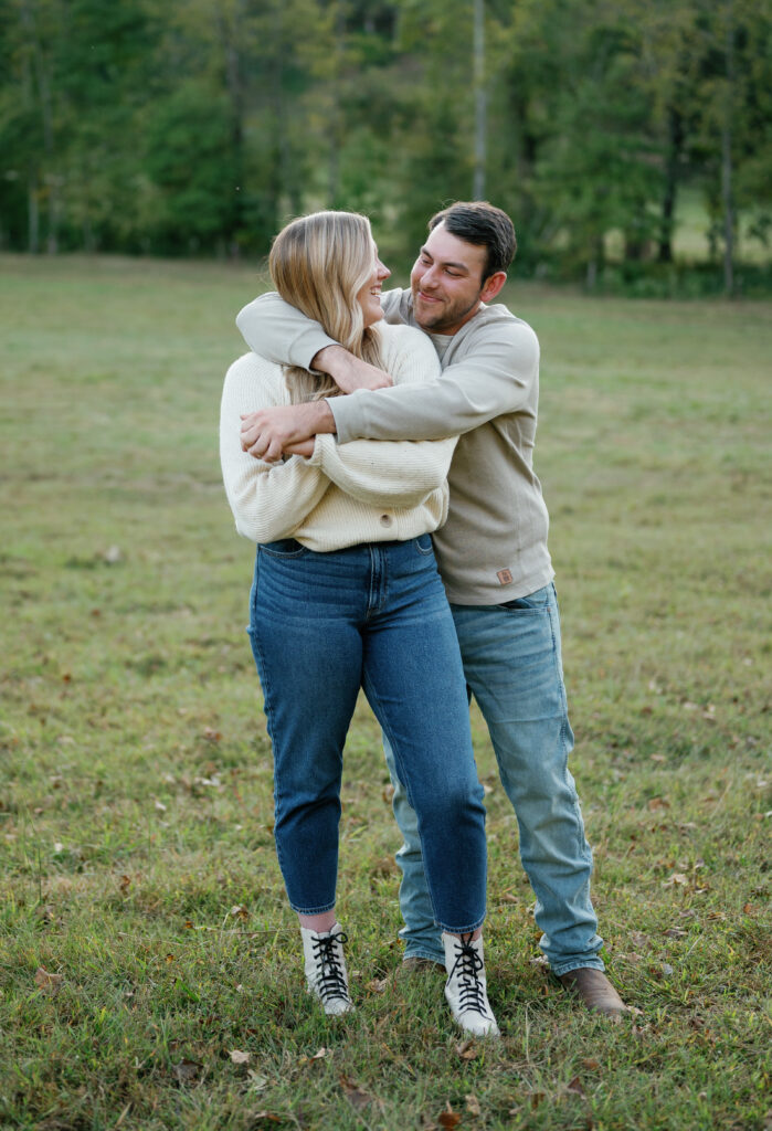 Couple posing in field for their Nashville Engagement pictures. 