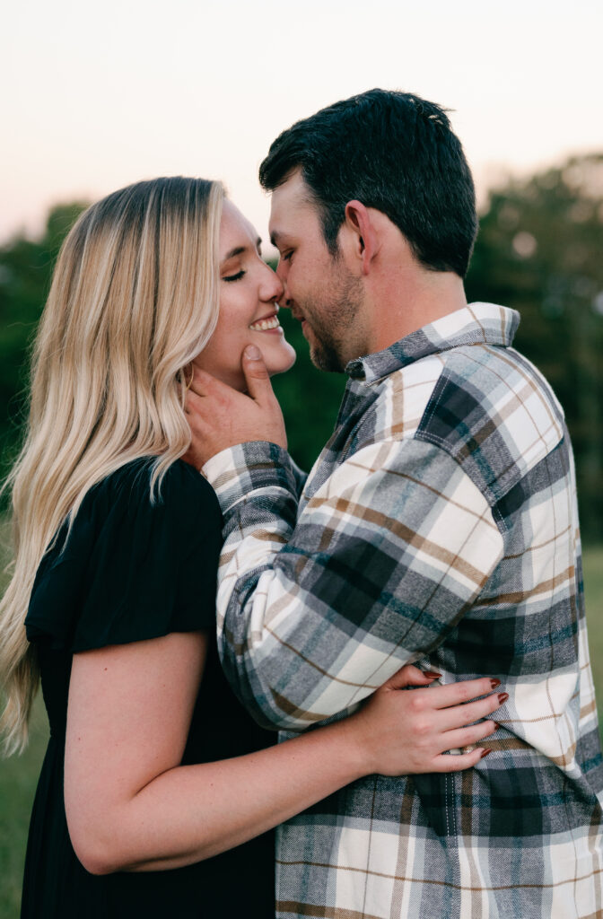 Couple posing in field for their Nashville Engagement pictures. 