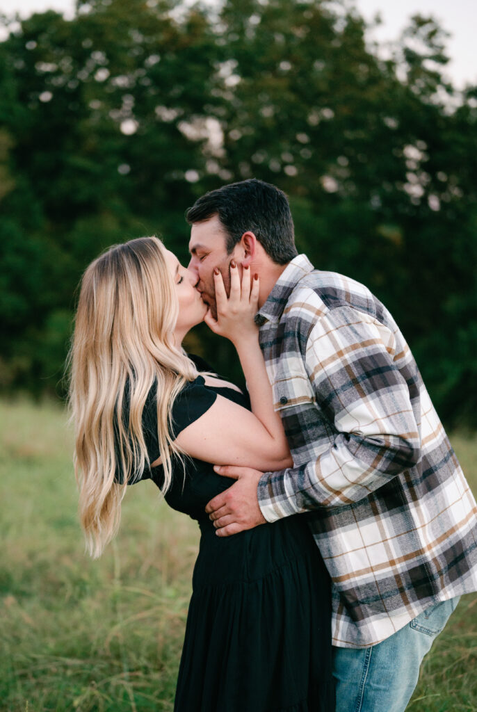 Couple posing in field for their Nashville Engagement pictures. 