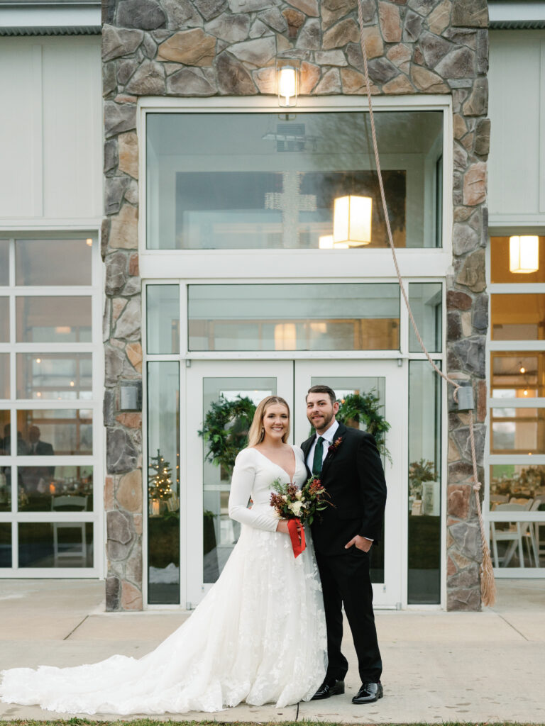 Bride and Groom posing in front of Ruby Cora wedding venue. 