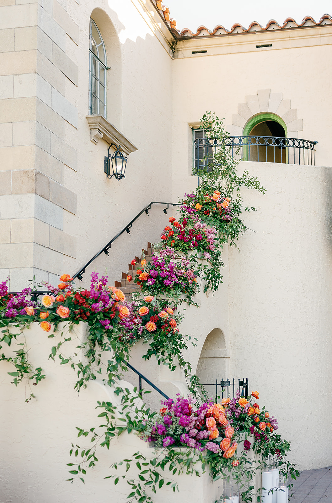 Details of a stairwell covered in colorful florals at the Powel Crosley Estate Wedding venue