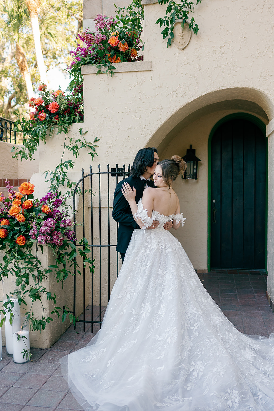 Newlyweds share an intimate moment under a flower covered stairwell at their Powel Crosley Estate Wedding