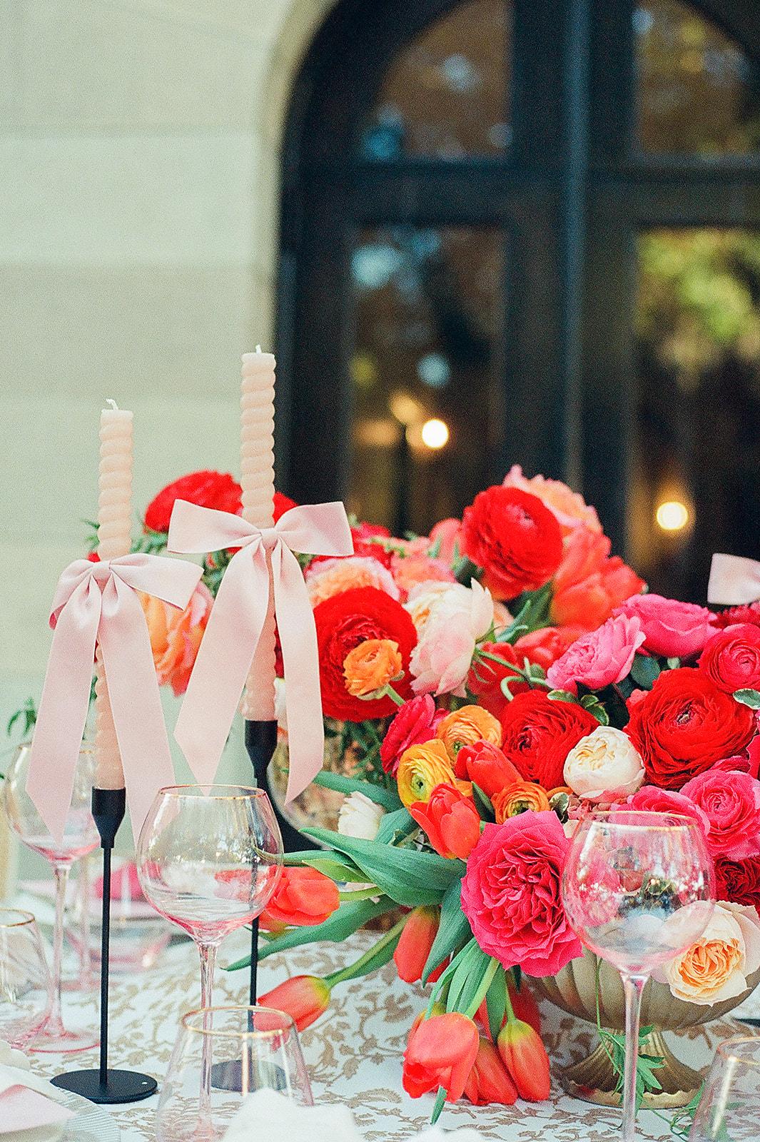 Details of a brightly covered wedding reception table set up outdoors