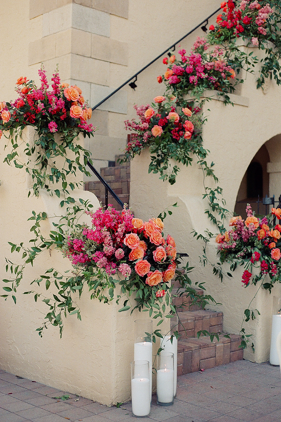 Details of a colorful floral covered set of brick and stucco stairs