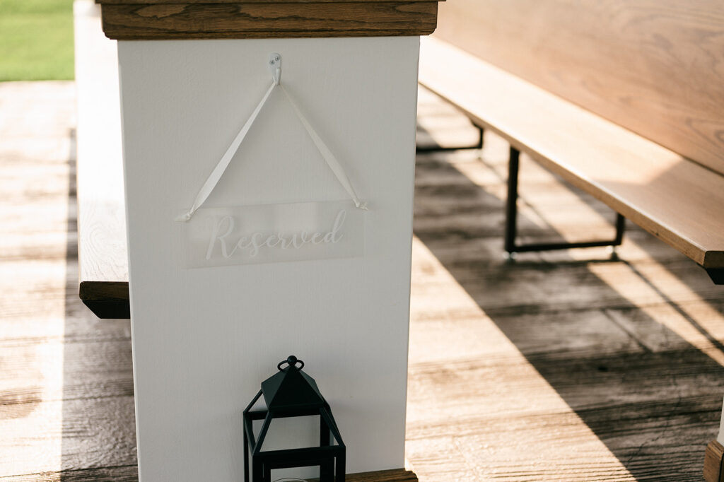 Details of a reserved sign hanging on a pew