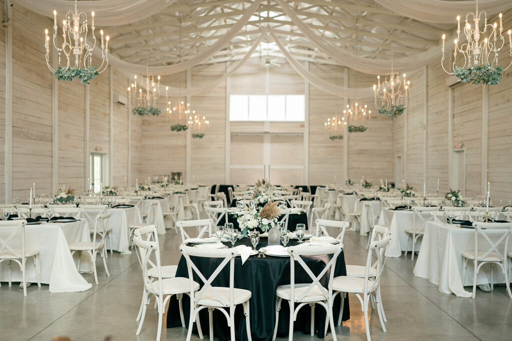 A peek into a black and white wedding reception inside The White Dove Barn wedding venue